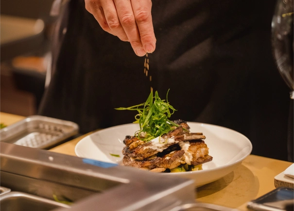 Chef adding garnish to a gourmet dish